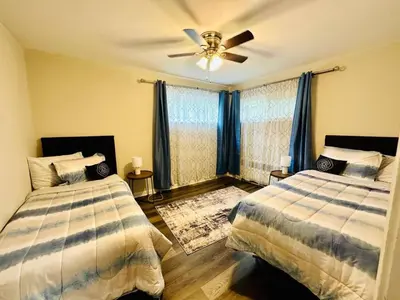 a bedroom with two beds and a ceiling fan at Cozy Retreat Apartment in Cincinnati