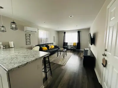 a kitchen and a living room with a counter top at Reading-Stylish Apartment for Contemporary Comfort in Cincinnati