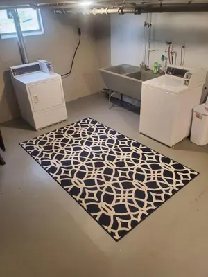 a bathroom with a bath tub and a rug at Reading-Stylish Apartment for Contemporary Comfort in Cincinnati