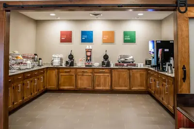 a large kitchen with wooden cabinets and a counter at Comfort Suites Hartville-North Canton in Uniontown