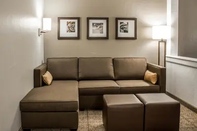 a living room with a couch in a room at Comfort Suites Hartville-North Canton in Uniontown