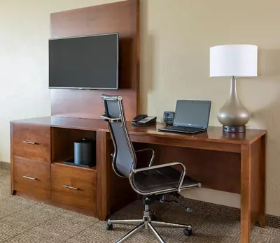 a desk with a laptop computer and a lamp at Comfort Suites Hartville-North Canton in Uniontown