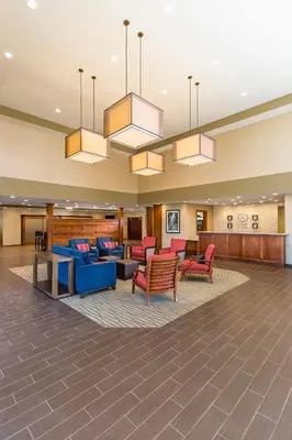 a lobby of a hospital with couches and chairs at Comfort Suites Hartville-North Canton in Uniontown
