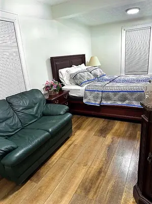 a bedroom with a bed and a couch at LOVELY FURNISHED HOUSE FOR rent in Akron