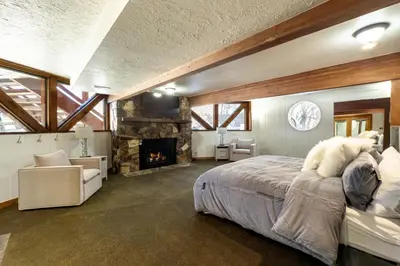 a bedroom with a large bed and a fireplace at Cozy Rustic Escape Near Park City Adventures in Defiance