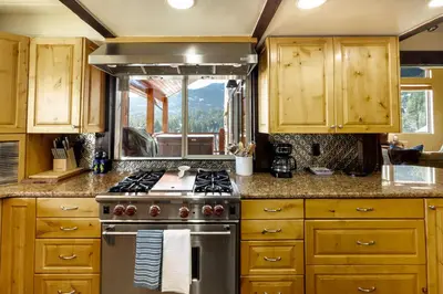 a kitchen with wooden cabinets and a stove top oven at Cozy Rustic Escape Near Park City Adventures in Defiance