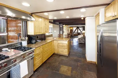 a kitchen with wooden cabinets and a stainless steel refrigerator at Cozy Rustic Escape Near Park City Adventures in Defiance