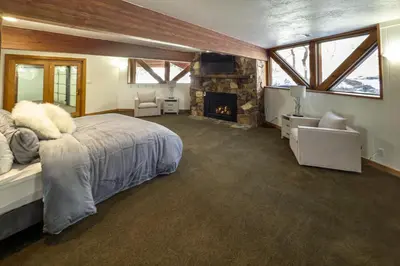 a bedroom with a large bed and a fireplace at Cozy Rustic Escape Near Park City Adventures in Defiance