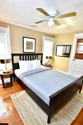 a bedroom with a large bed with a ceiling fan at Lakewood Central Haven in Cleveland