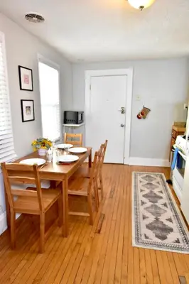 a dining room with a wooden table and chairs at Lakewood Central Haven in Cleveland