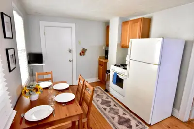 a kitchen with a table and a white refrigerator at Lakewood Central Haven in Cleveland
