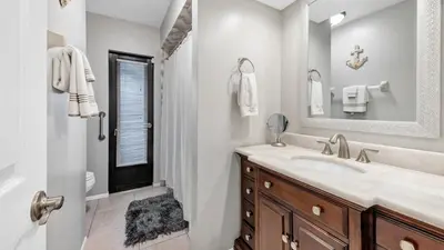 a bathroom with a sink and a shower and a mirror at BLC200 in Lawrenceburg