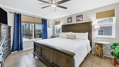 a bedroom with a large bed with blue curtains at BLC200 in Lawrenceburg