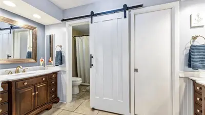 a bathroom with a white shower door and a toilet at BLC200 in Lawrenceburg