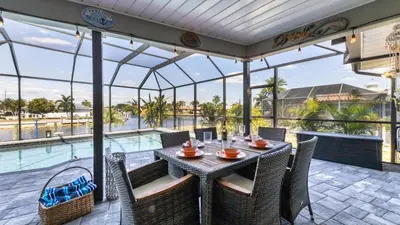 a patio with a table and chairs and a pool at BLC200 in Lawrenceburg