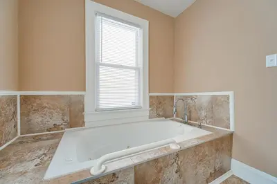 a bath tub in a bathroom with a window at 11 Mi to Dtwn Cleveland Family Home with Yard in Garfield Heights