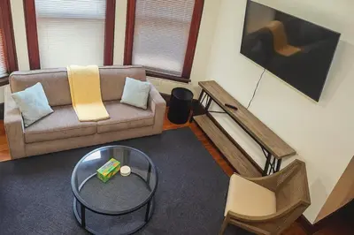 a living room with a couch and a table at Victorian Cozy Retreat Steps to Cleveland Clinic in Cleveland