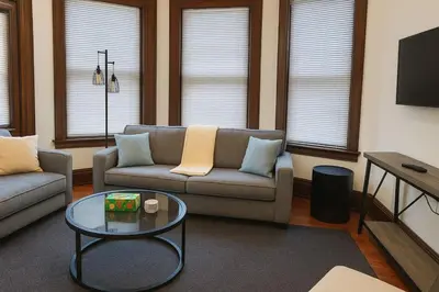 a living room with a couch and a table at Victorian Cozy Retreat Steps to Cleveland Clinic in Cleveland