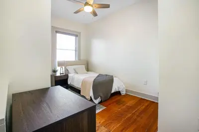 a bedroom with a bed and a ceiling fan at Victorian Cozy Retreat Steps to Cleveland Clinic in Cleveland