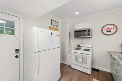 a kitchen with a white refrigerator and a stove at Walkable Neighborhood of Kamm's Corners in Cleveland