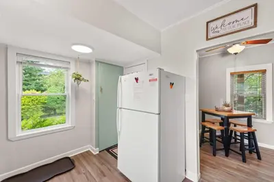 a kitchen with a white refrigerator and a table at Walkable Neighborhood of Kamm's Corners in Cleveland