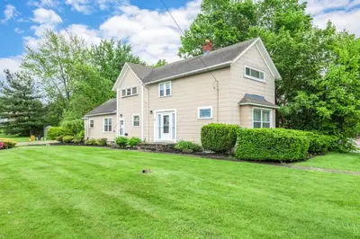 a house with a green lawn in front of it at Walkable Neighborhood of Kamm's Corners in Cleveland