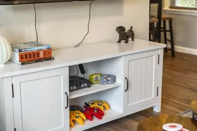 a white shelf with toys on it in a living room at Double the Space for Large Groups Entire Duplex in Cleveland