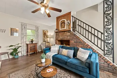 a living room with a blue couch and a fireplace at Double the Space for Large Groups Entire Duplex in Cleveland