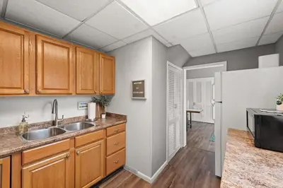 a kitchen with a sink and a refrigerator at Double the Space for Large Groups Entire Duplex in Cleveland