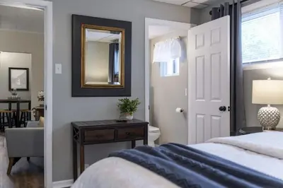 a bedroom with a bed and a mirror on the wall at Double the Space for Large Groups Entire Duplex in Cleveland