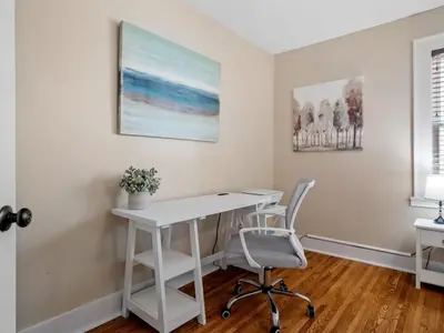 a white desk and two chairs in a room at Cleveland 3 Bedroom, 10 Mins to Downtown in Cleveland