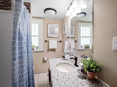 a bathroom with a sink and a mirror at Cleveland 3 Bedroom, 10 Mins to Downtown in Cleveland