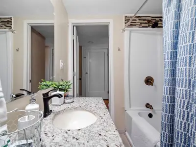 a bathroom with a sink and a bath tub at Cleveland 3 Bedroom, 10 Mins to Downtown in Cleveland