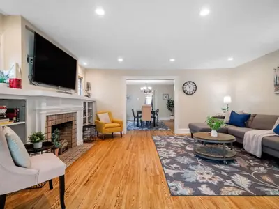 a living room with a couch and a fireplace at 6 Bedroom Entire Duplex for Large Groups in Cleveland