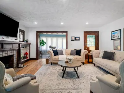 a living room with a couch and a table at 6 Bedroom Entire Duplex for Large Groups in Cleveland