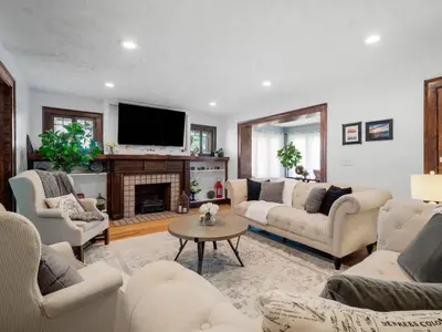 a living room with white furniture and a fireplace at 6 Bedroom Entire Duplex for Large Groups in Cleveland