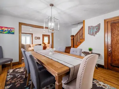 a dining room with a wooden table and chairs at 6 Bedroom Entire Duplex for Large Groups in Cleveland