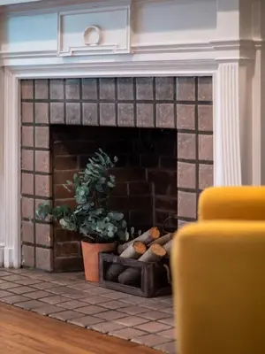 a brick fireplace with a potted plant in a living room at 6 Bedroom Entire Duplex for Large Groups in Cleveland