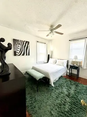 a bedroom with a bed and a ceiling fan at Cozy Home By University Circle VA,CC & Museum in Cleveland