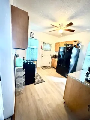 a kitchen with a black refrigerator and a counter at Cozy Home By University Circle VA,CC & Museum in Cleveland