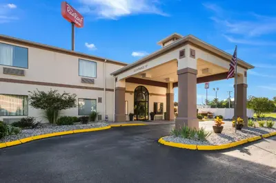 a rendering of a hotel building with a flag at Red Roof Inn Carrollton in Carrollton