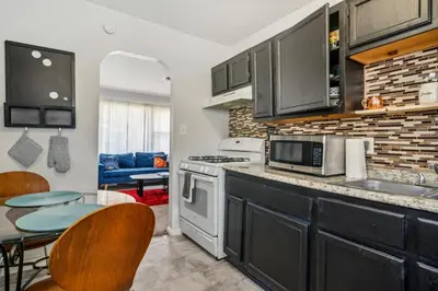 a kitchen with a sink and a stove at Cozy two bedroom one bath in Cleveland