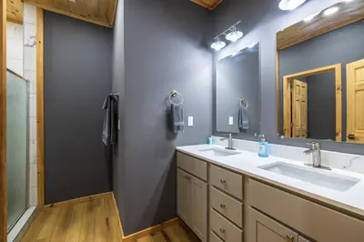 a bathroom with two sinks and a mirror at New listing-- Hocking Hills Modern Cabin in Logan