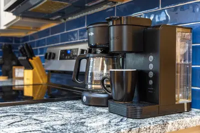 a coffee maker sitting on a counter in a kitchen at New listing-- Hocking Hills Modern Cabin in Logan