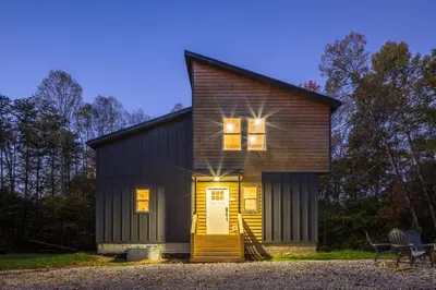 a small house with a yellow door and windows at New listing-- Hocking Hills Modern Cabin in Logan