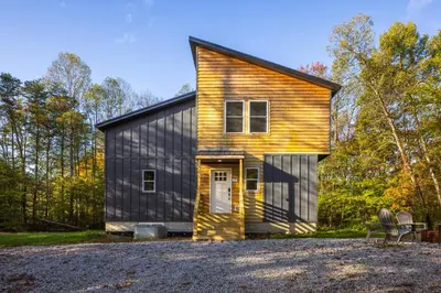 a small house with a gambrel roof at New listing-- Hocking Hills Modern Cabin in Logan