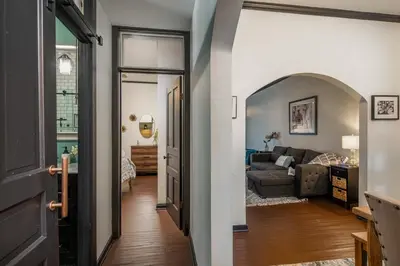 a hallway leading to a living room with a couch at Blame Jaime - downtown, the heart of all the fun! in Port Clinton