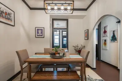 a dining room with a wooden table and chairs at Blame Jaime - downtown, the heart of all the fun! in Port Clinton