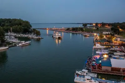 a group of boats docked in a harbor at night at Blame Jaime - downtown, the heart of all the fun! in Port Clinton