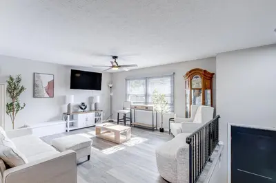 a living room with white furniture and a flat screen tv at 3 Mi to Cuyahoga Valley NP Fairlawn Family Home! in Fairlawn
